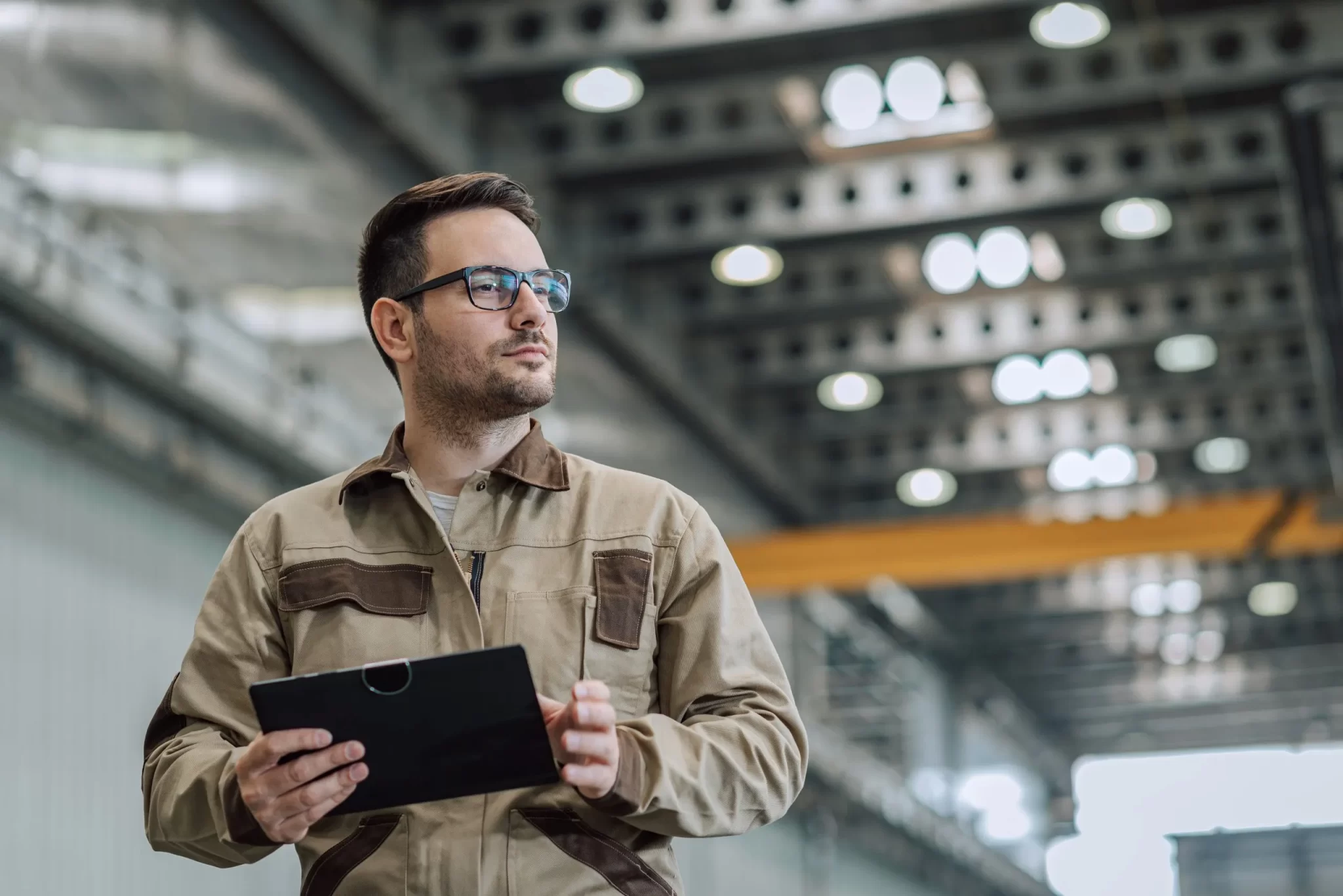 Portrait of a foreman at manufacturing plant, close-up, low angle view.